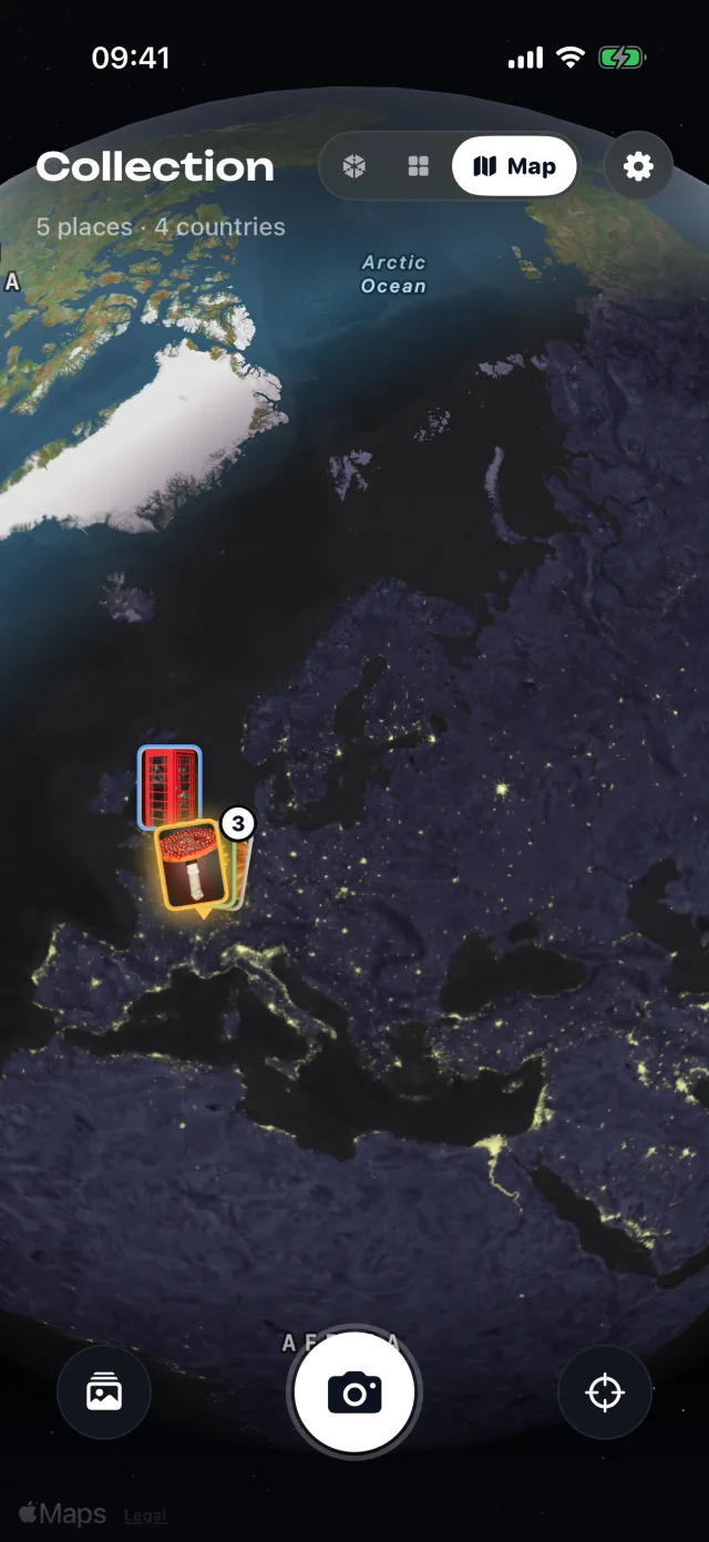 A night-lit globe with card pins over Europe